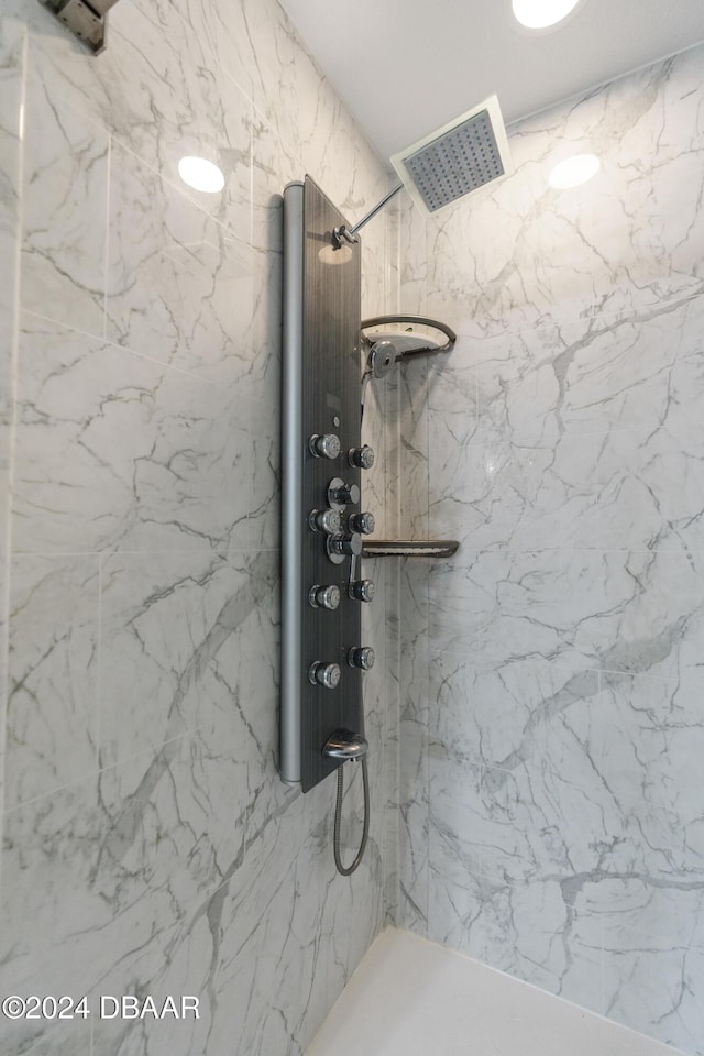 room details with visible vents and a marble finish shower