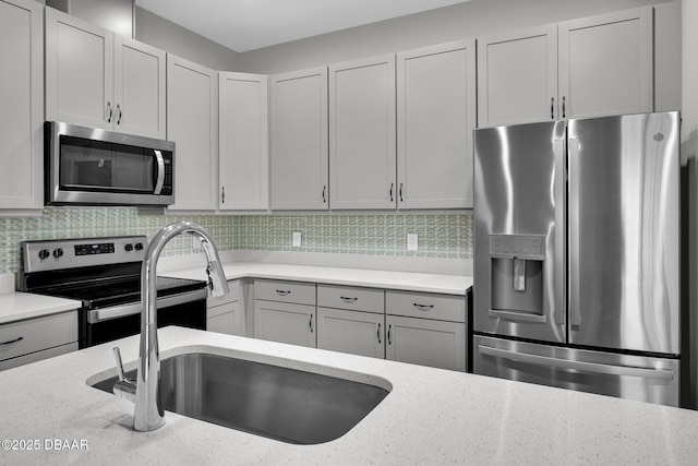 906 Coral Reef Way, Daytona Beach, FL 32124 - kitchen featuring stainless steel appliances, light stone countertops, backsplash, and gray cabinets