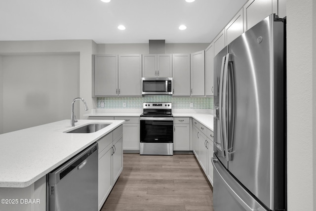 906 Coral Reef Way, Daytona Beach, FL 32124 - kitchen with appliances with stainless steel finishes, light wood-type flooring, recessed lighting, backsplash, and an island with sink