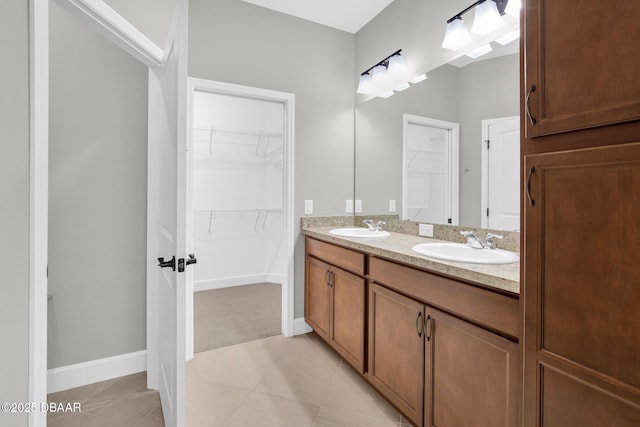 906 Coral Reef Way, Daytona Beach, FL 32124 - bathroom with double vanity, a spacious closet, and tile patterned floors