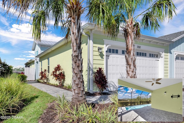 906 Coral Reef Way, Daytona Beach, FL 32124 - view of property exterior featuring a garage, a ceiling fan, and board and batten siding
