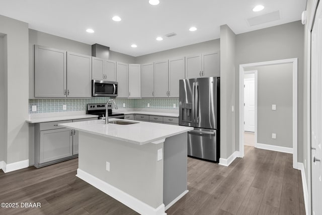 906 Coral Reef Way, Daytona Beach, FL 32124 - kitchen featuring stainless steel appliances, dark wood-type flooring, a center island with sink, decorative backsplash, and recessed lighting