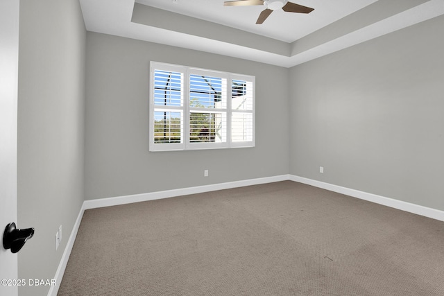 906 Coral Reef Way, Daytona Beach, FL 32124 - unfurnished room with a ceiling fan, dark carpet, and a raised ceiling