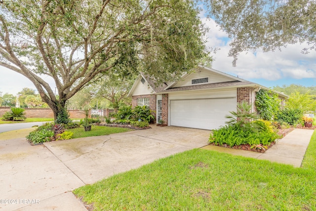 view of front of home featuring a garage and a front lawn