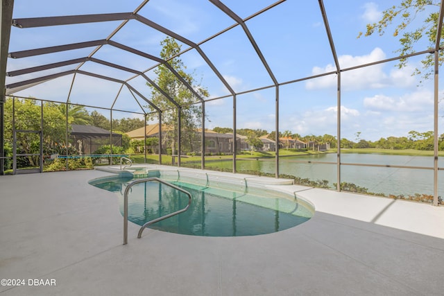 view of swimming pool featuring glass enclosure, a water view, and a patio