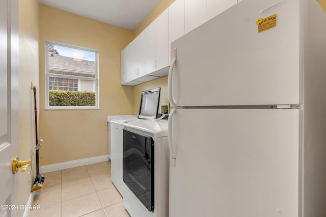 washroom featuring washer hookup, cabinets, and light tile patterned floors