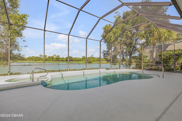 view of pool featuring glass enclosure, a patio area, a water view, and an in ground hot tub