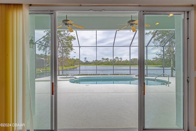 view of swimming pool featuring ceiling fan, an in ground hot tub, and a water view