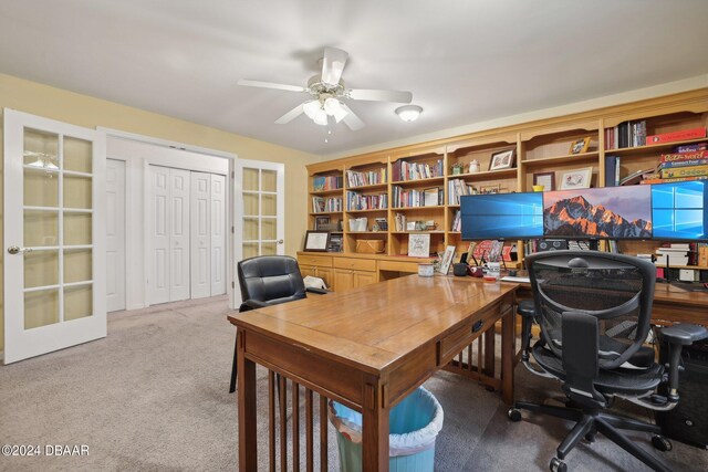 carpeted office with french doors and ceiling fan