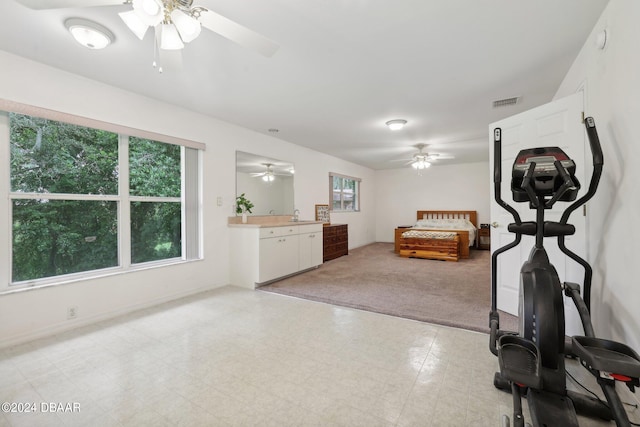 interior space featuring sink, light carpet, and ceiling fan