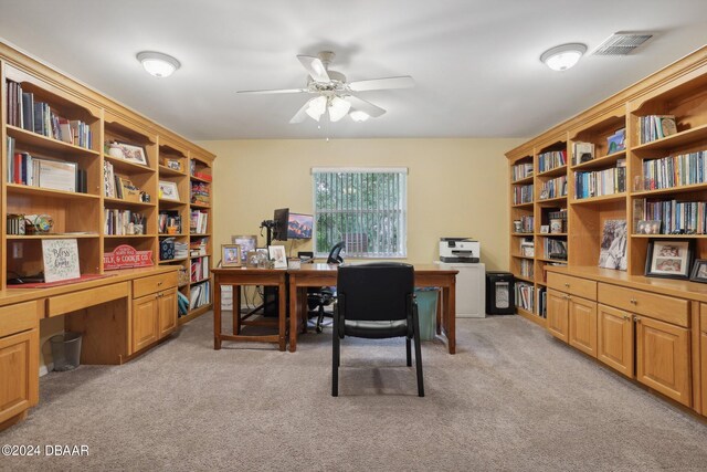 office area featuring light carpet and ceiling fan