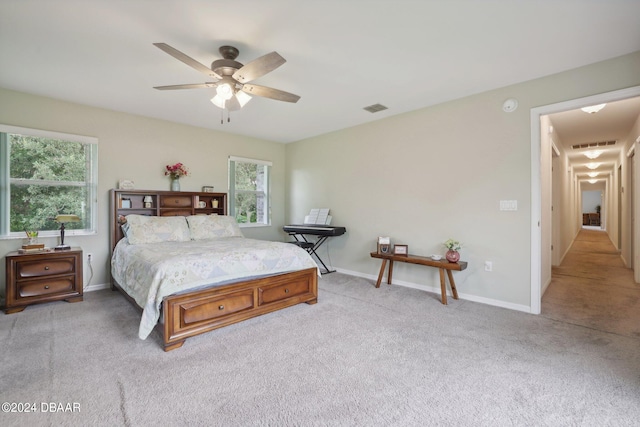 bedroom featuring light carpet and ceiling fan