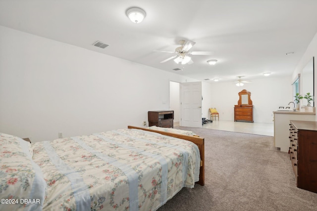 bedroom featuring light carpet and ceiling fan