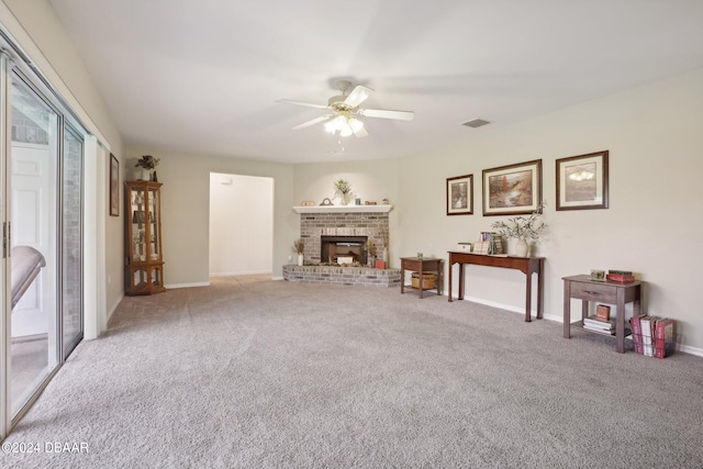 carpeted living room featuring ceiling fan and a fireplace