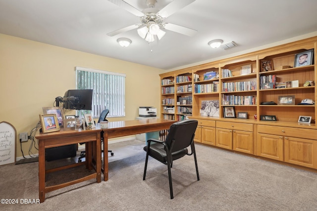 carpeted office space with ceiling fan