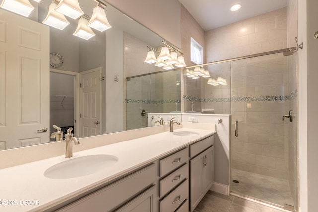 bathroom with vanity, tile patterned flooring, and a shower with door