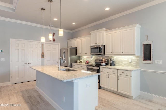 kitchen with sink, white cabinets, a kitchen island with sink, stainless steel appliances, and light stone countertops