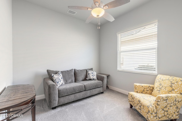 carpeted living room with ceiling fan