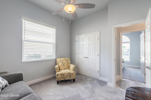 sitting room featuring light colored carpet and ceiling fan