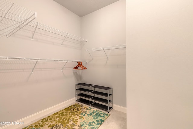 spacious closet featuring light tile patterned flooring