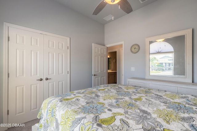 bedroom with ceiling fan, lofted ceiling, and a closet