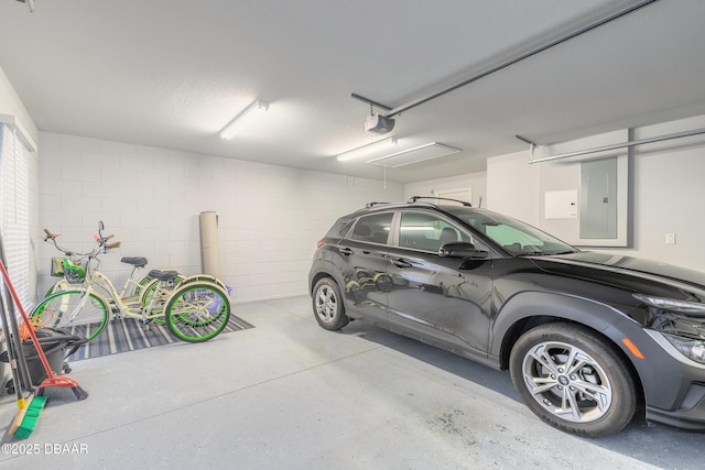 garage with a garage door opener and electric panel