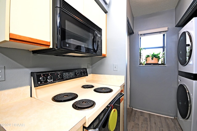 kitchen featuring a textured ceiling, white range with electric cooktop, dark hardwood / wood-style floors, and stacked washer / dryer