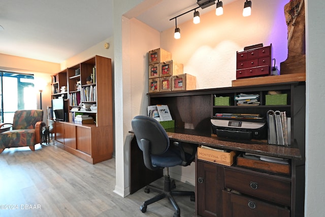 office featuring light hardwood / wood-style flooring and rail lighting