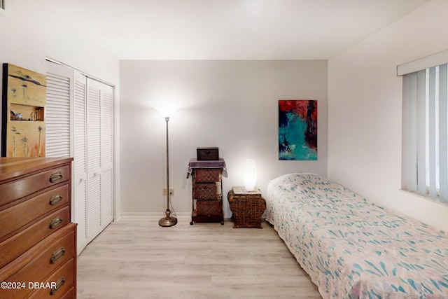 bedroom with a closet and light hardwood / wood-style floors