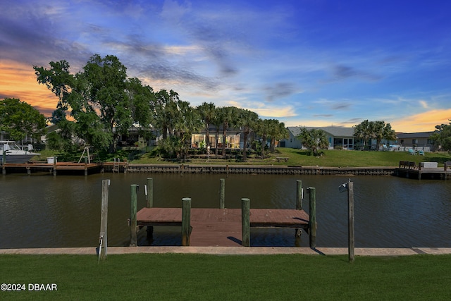 dock area featuring a yard and a water view