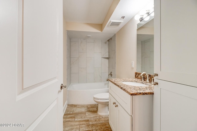 bathroom with visible vents, toilet, shower / bath combination, wood finished floors, and vanity