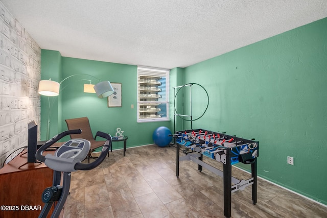 recreation room featuring a textured ceiling