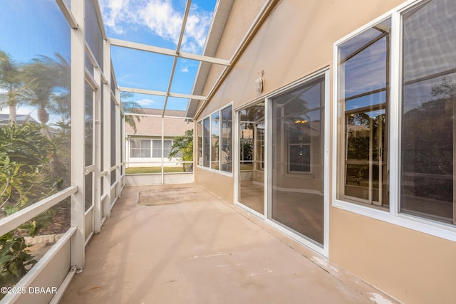 unfurnished sunroom featuring vaulted ceiling