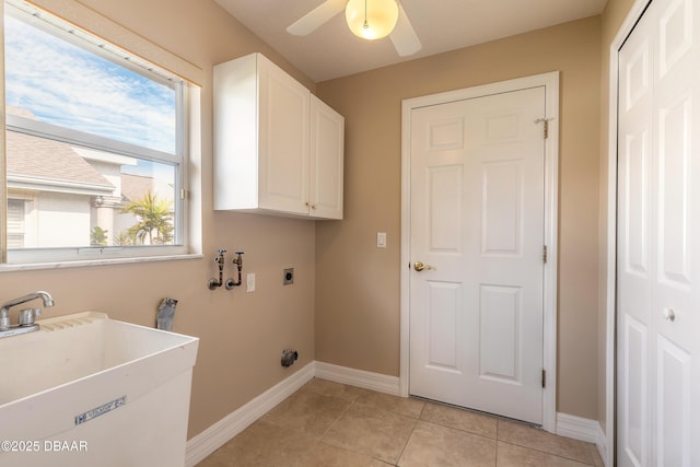 laundry room featuring light tile patterned floors, sink, ceiling fan, hookup for an electric dryer, and cabinets