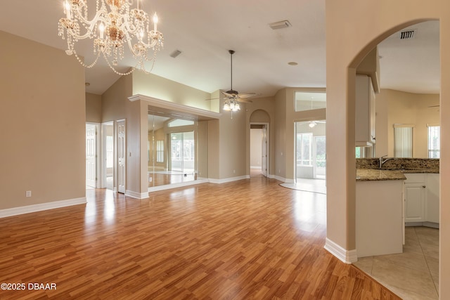 unfurnished living room with sink, light hardwood / wood-style flooring, and ceiling fan