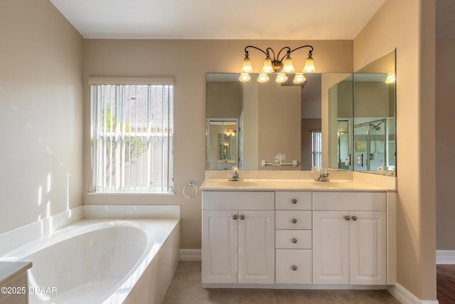 bathroom featuring vanity, a washtub, and tile patterned floors