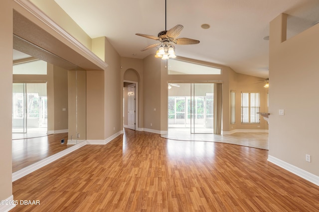 empty room with light wood-type flooring, high vaulted ceiling, and ceiling fan