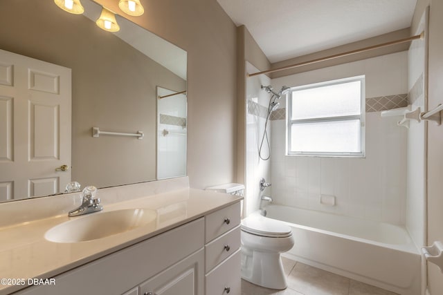 full bathroom featuring toilet, vanity, tiled shower / bath, and tile patterned flooring