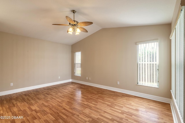 unfurnished room featuring ceiling fan, a healthy amount of sunlight, light hardwood / wood-style flooring, and lofted ceiling