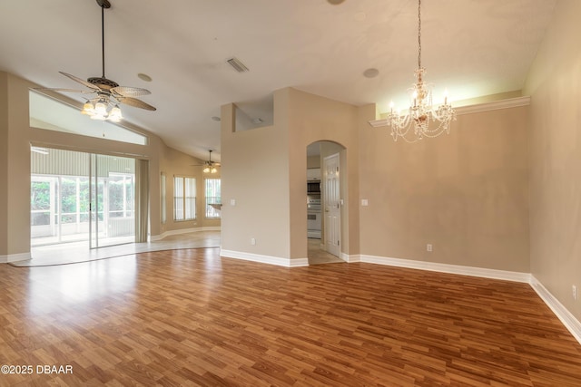 spare room featuring ceiling fan with notable chandelier, hardwood / wood-style floors, and lofted ceiling