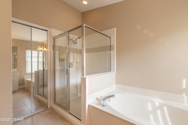 bathroom featuring plus walk in shower and tile patterned floors