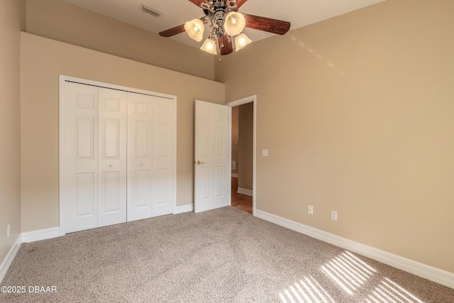 unfurnished bedroom with carpet flooring, a closet, and ceiling fan