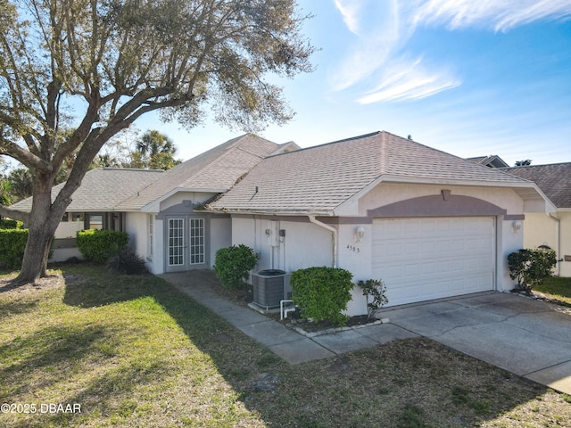 single story home featuring french doors, a front lawn, an attached garage, and a shingled roof