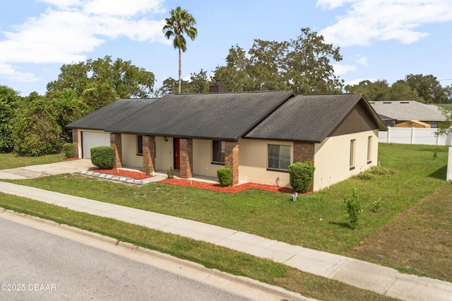 ranch-style house featuring a front yard and a garage