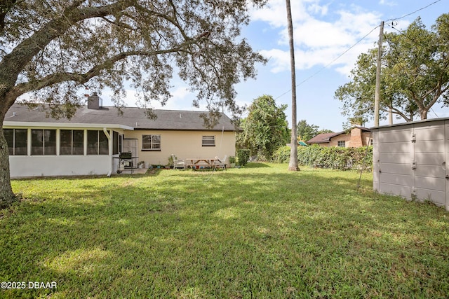 view of yard with a sunroom