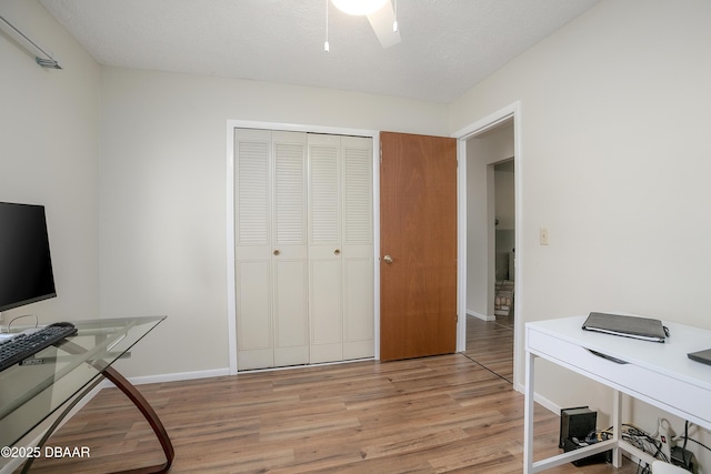 home office featuring a textured ceiling and light wood-type flooring