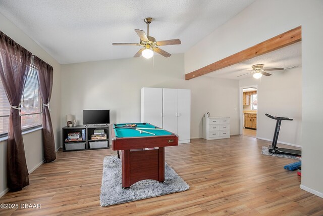 recreation room featuring ceiling fan, a textured ceiling, and light wood-type flooring