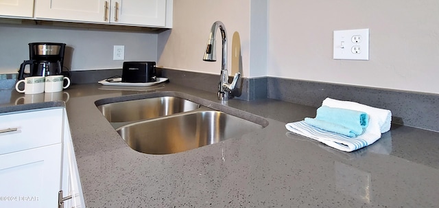 kitchen with white cabinetry and sink