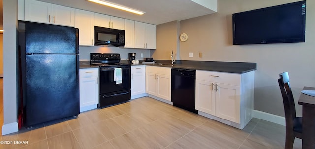 kitchen with light tile patterned flooring, sink, white cabinets, and black appliances