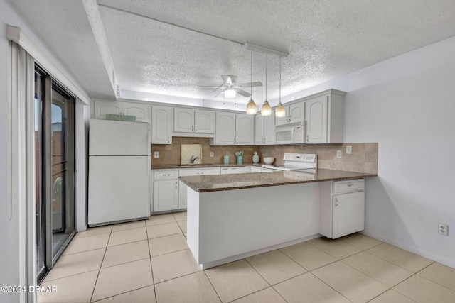 kitchen with white appliances, ceiling fan, decorative backsplash, and kitchen peninsula